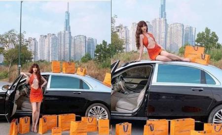 Ngọc Trinh diện đồ cắt xẻ khoe vòng 1 căng đét tạo dáng bên 'xế hộp' tiền tỷ, bất ngờ loạt đồ hiệu để xung quanh